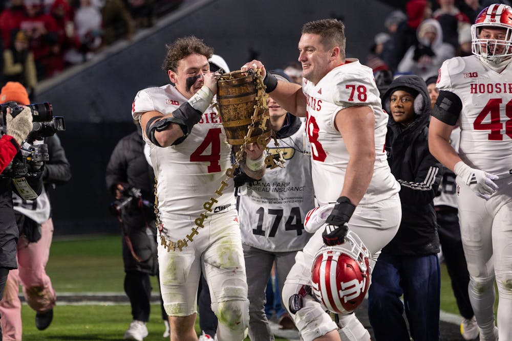 Aiden Fisher (4) and Pat Coogan carry the Old Oaken Bucket after Indiana's win over Purdue on Nov. 28, 2025. (HN photo/Shelby Gosser)