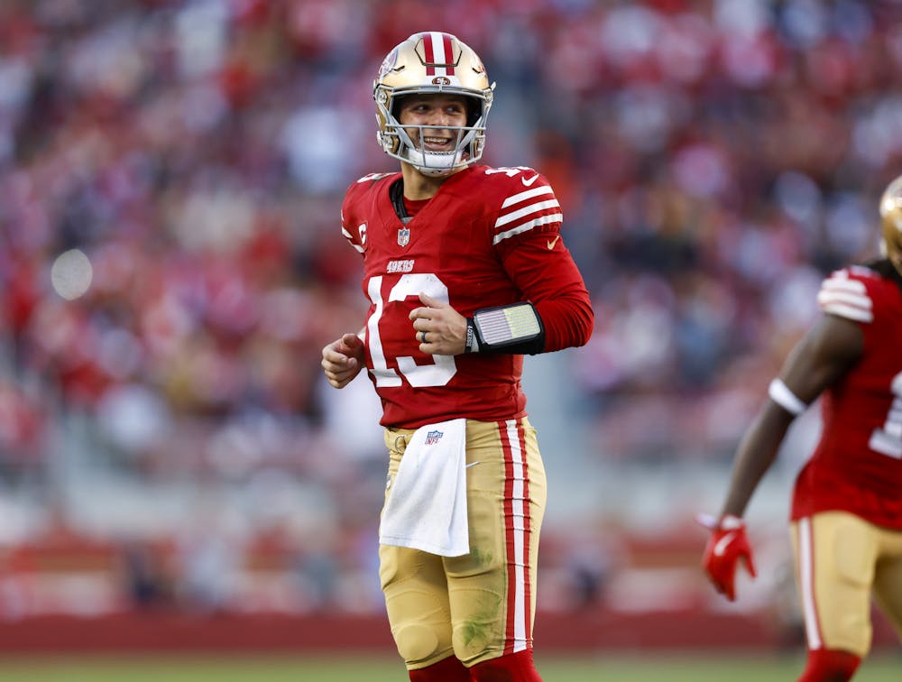 San Francisco 49ers starting quarterback Brock Purdy (13) smiles after San Francisco 49ers' Patrick Taylor Jr. (32) scored a touchdown against the Chicago Bears in the fourth quarter at Levi's Stadium in Santa Clara, Calif., on Sunday, Dec. 8, 2024. (Nhat V. Meyer/Bay Area News Group/Tribune Content Agency)