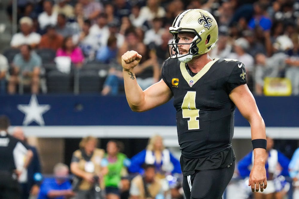 New Orleans Saints quarterback Derek Carr celebrates a touchdown run by running back Alvin Kamara during the second half of an NFL football game against the Dallas Cowboys at AT&T Stadium on Sunday, Sept. 15, 2024, in Arlington. (Smiley N. Pool/Tribune News Service)