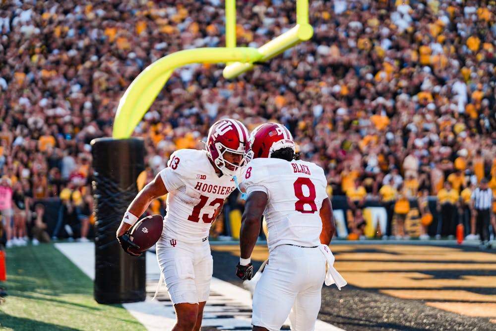 Elijah Sarratt (left) and Kaelon Black celebrate Sarratt's game-winning touchdown during Indiana’s win at Iowa on Sat. 27, 2025. (HN photo/Shrithik Karthik)