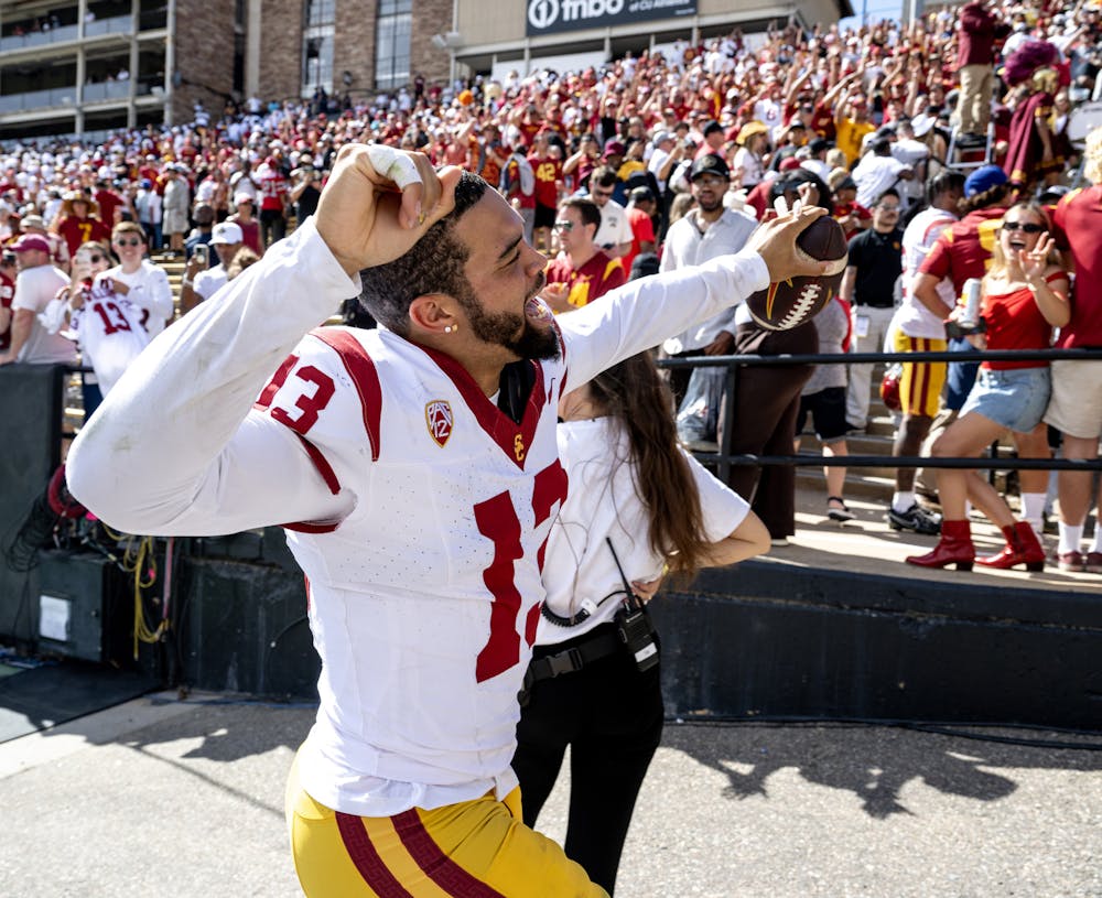 USC quarterback Caleb Williams (13) celebrates with fans as he leaves the field following a 48-41 win against Colorado at Folsom Field on Saturday, Sept. 30, 2023, in Boulder, Colorado. (Gina Ferazzi/Los Angeles Times/Tribune News Service)