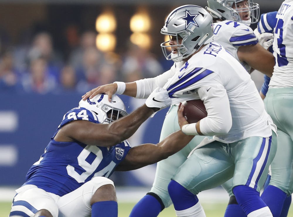 Indianapolis Colts defensive end Tyquan Lewis (94) takes down Dallas Cowboys quarterback Dak Prescott (4) for a first half sack on Sunday, Dec. 16, 2018 at Lucas Oil Stadium in Indianapolis, Ind. (Sam Riche/TNS)