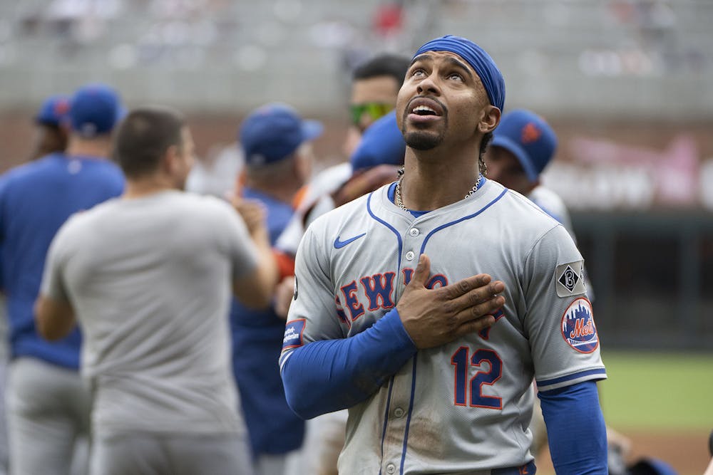 Francisco Lindor #12 of the New York Mets looks up as he returns to the dugout after hitting a two-run home run to win the game in the ninth inning of game one of a doubleheader against the Atlanta Braves at Truist Park on Sept. 30, 2024, in Atlanta, Georgia. (Edward M. Pio Roda/Getty Images/TNS)