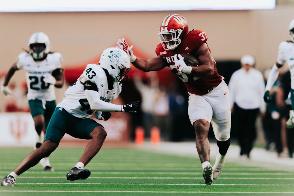 Riley Nowakowski stiff-arms a Spartan during Indiana's win over Michigan State on Oct. 18, 2025. (HN photo/Jake Weinberg)