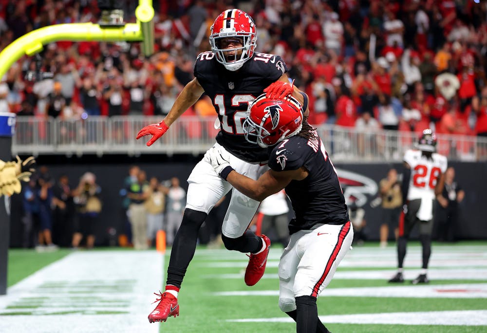 Atlanta Falcons wide receiver KhaDarel Hodge (12) celebrates with running back Bijan Robinson (7) after a game-winning, 45-yard touchdown reception against the Tampa Bay Buccaneers during overtime at Mercedes-Benz Stadium on Thursday, Oct. 3, 2024, in Atlanta. (Kevin C. Cox/Getty Images/TNS)