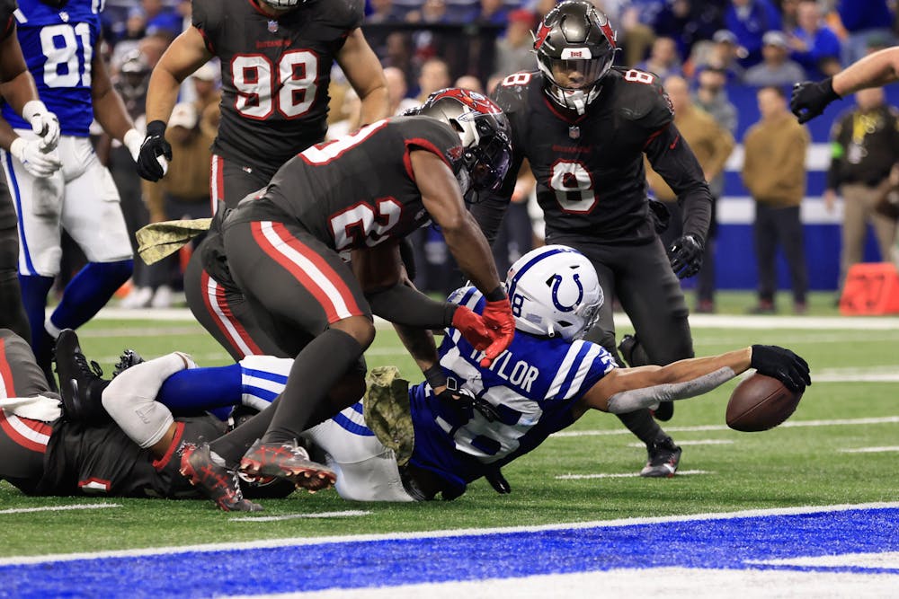Jonathan Taylor (28) of the Indianapolis Colts reaches with the ball for a first down in the fourth quarter against the Tampa Bay Buccaneers at Lucas Oil Stadium on Sunday, Nov. 26, 2023, in Indianapolis. (Justin Casterline/Getty Images/TNS)