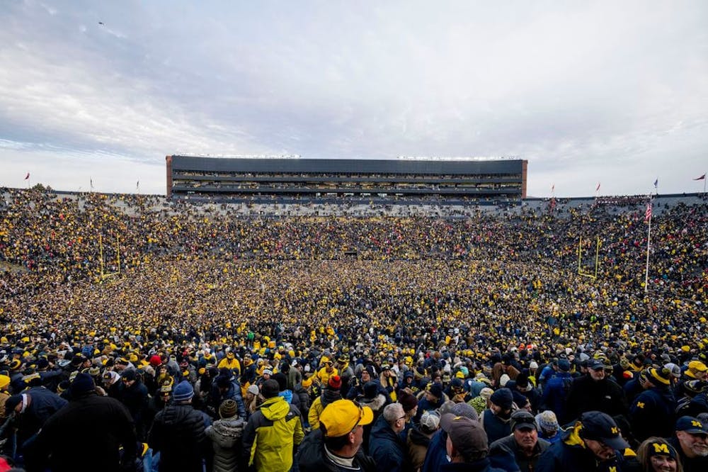 Fans rush the field after Michigan defeated Ohio State 30-24 at Michigan Stadium in Ann Arbor on Saturday, Nov. 25 2023. (Jacob Hamilton | jhamilt3 | Tribune Content Agency)