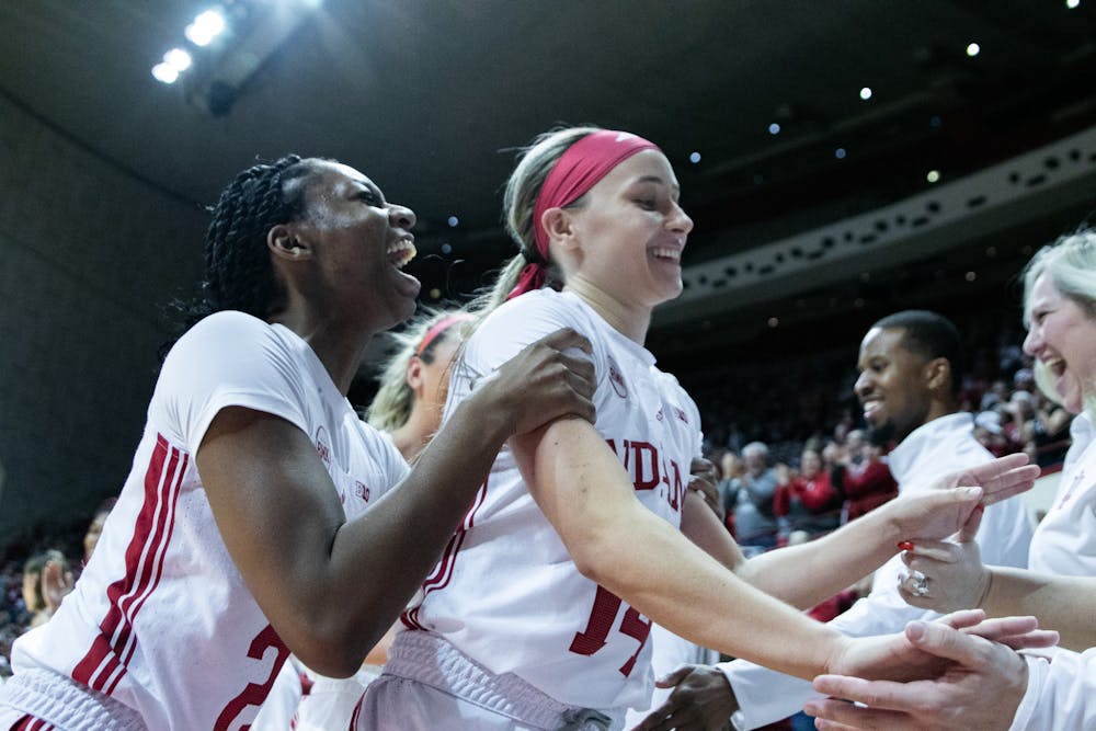 Sara Scalia (14) celebrates with Chloe Moore-McNeil and other teammates during Indiana's win over Bowling Green on Dec. 22, 2023. (HN photo/Giselle Marsteller)