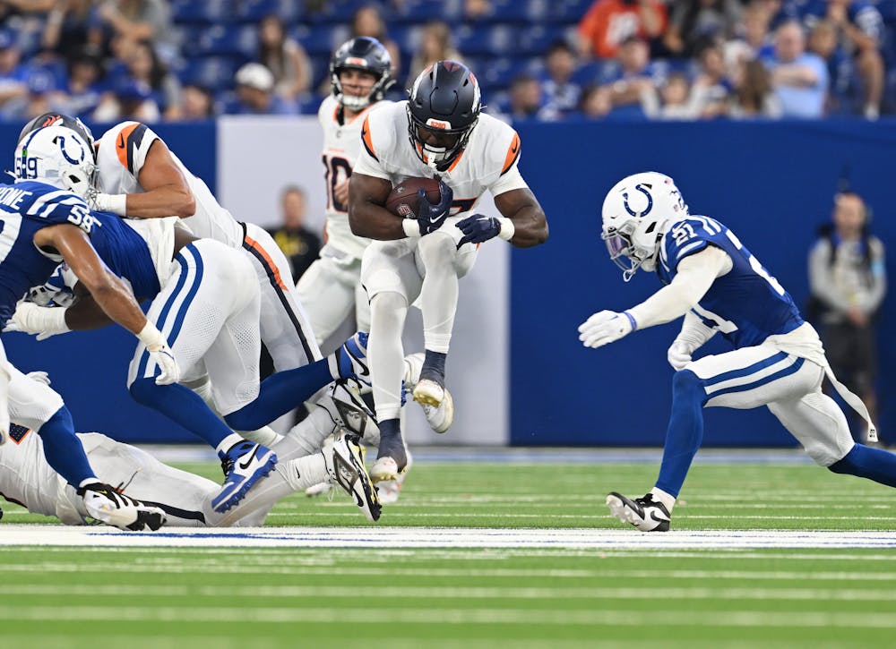 Denver Broncos running back Audric Estime (37) runs the ball up the field at Lucas Oil Stadium in Indianapolis, Indiana on Aug. 11, 2024. The Indianapolis Colts hosted the Denver Broncos for their first NFL Preseason game of the 2024 summer. (Photo by RJ Sangosti/The Denver Post)