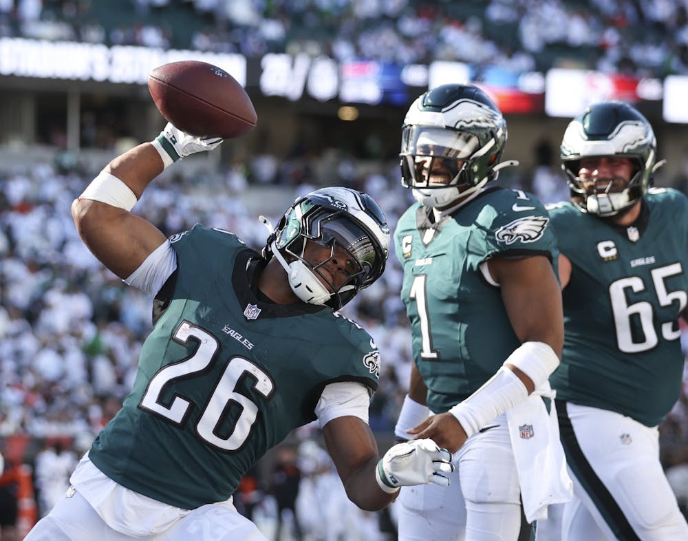 Eagles running back Saquon Barkley spikes the football after quarterback Jalen Hurts scored a fourth-quarter touchdown against Cincinnati Bengals on Sunday. (David Maialetti/Tribune Content Agency)