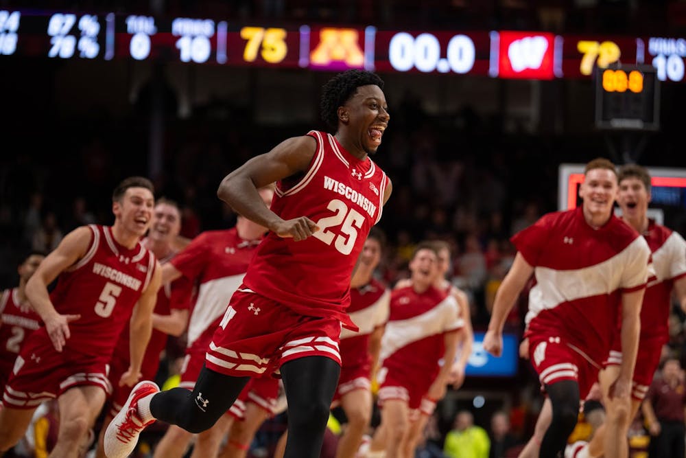 Wisconsin guard John Blackwell (25) leads teammates in a victory lap after hitting the winning three-pointer at the buzzer in the Badgers' 78-75 win over the Gophers on Tuesday, Jan. 13, at Williams Arena. (Jeff Wheeler / The Minnesota Star Tribune/Tribune Content Agency)