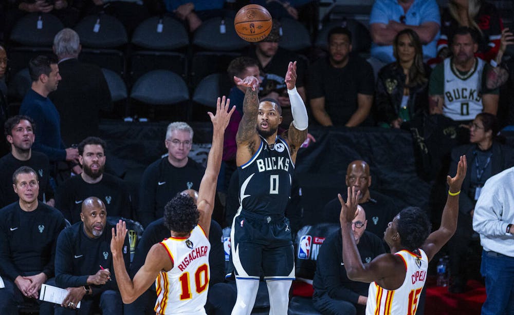 Milwaukee Bucks guard Damian Lillard (0) elevates for a three-point basket between Atlanta Hawks forward Zaccharie Risacher (10) and center Clint Capela (15) during the first half of their NBA Cup semifinal game at the T-Mobile Arena on Saturday, Dec. 14, 2024, in Las Vegas. (L.E. Baskow/Las Vegas Review-Journal/Tribune Content Agency) @Left_Eye_Images