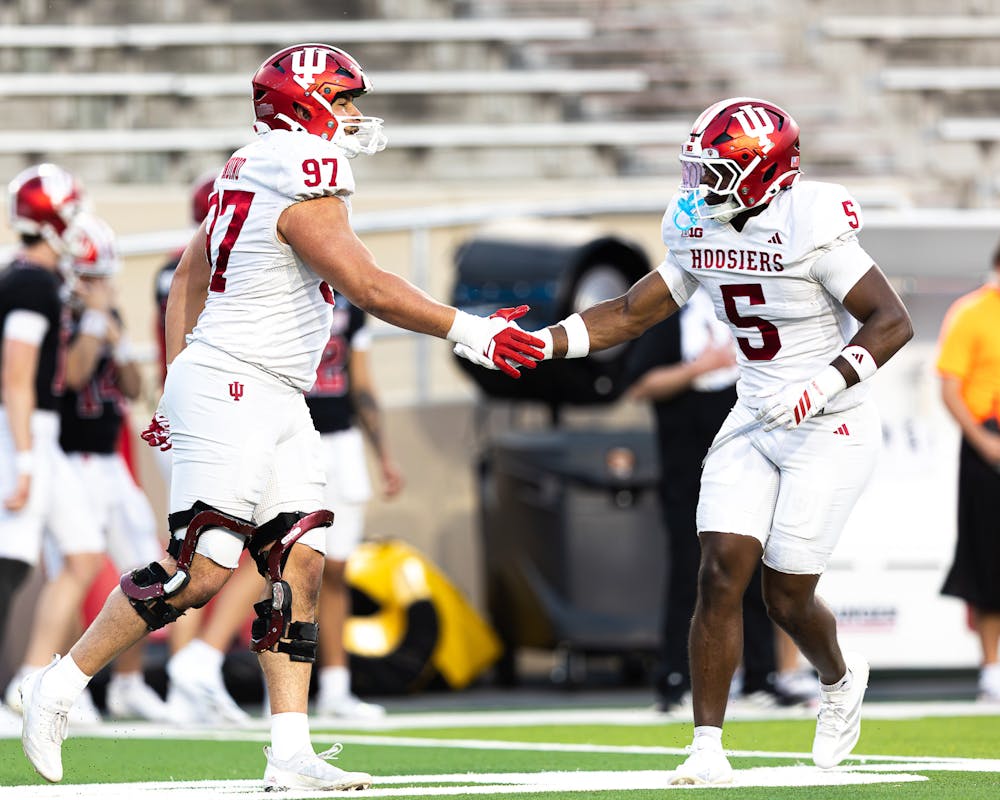 Mario Landino, left, high-fives Rolijah Hardy during the Indiana football Spring Game at Merchants Bank Field at Memorial Stadium in Bloomington, Indiana — (Photo by Brady Owen / The Hoosier Network)