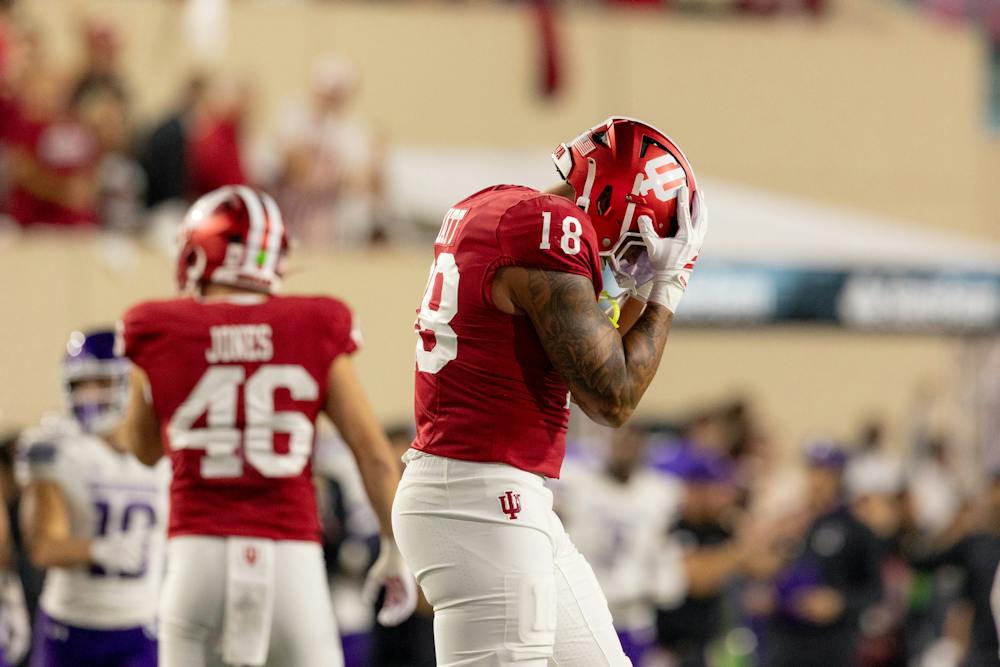 Kellan Wyatt puts his head in his hands during Indiana's win over Northwestern at Memorial Stadium on Friday, Sept. 25, 2026. (HN photo/Lauren McKinney)