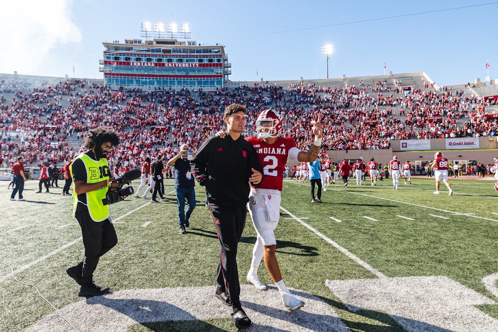 Indiana quarterbacks Kurtis Rourke (left) and Tayven Jackson (right) celebrate with fans following Indiana's 56-7 win over Nebraska on Oct. 19, 2024. (HN photo/Kallan Graybill)