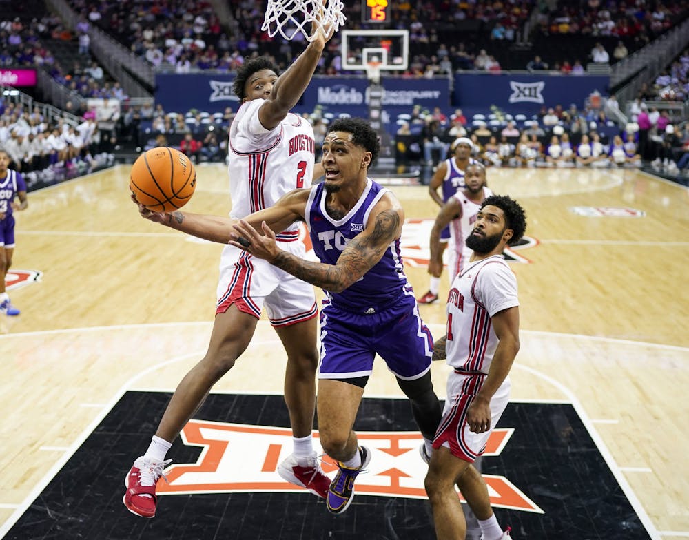 Texas Christian's Micah Peavy (0) shoots against Houston's Cedric Lath (2) and Damian Dunn (11) in the first half during the quarterfinals of the Big Tournament at T-Mobile Center on Thursday, March 14, 2024, in Kansas City, Missouri. (Jay Biggerstaff/Getty Images/TNS)