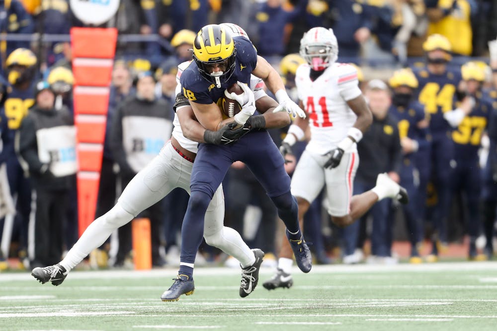 Michigan tight end Colston Loveland (18) catches the ball as Ohio State safety Sonny Styles (6) tries to bring him down during the game at Michigan Stadium in Ann Arbor on Saturday, Nov. 25, 2023. (Neil Blake | MLive.com)