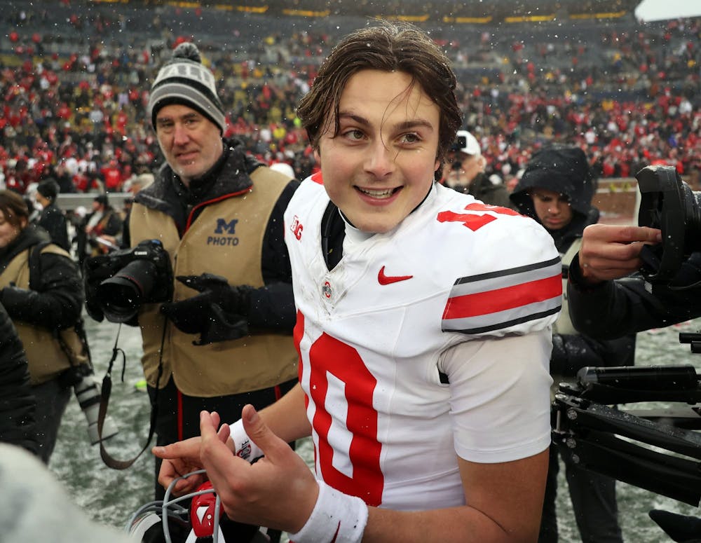 Buckeyes quarterback Julian Sayin (10) celebrates after the end of the college football game between the Ohio State Buckeyes and the Michigan Wolverines in Ann Arbor on Saturday, November 29, 2025.  The Buckeyes won 27-9 to advance to the Big 10 Conference Championship game. (David Petkiewicz/Tribune Content Agency)