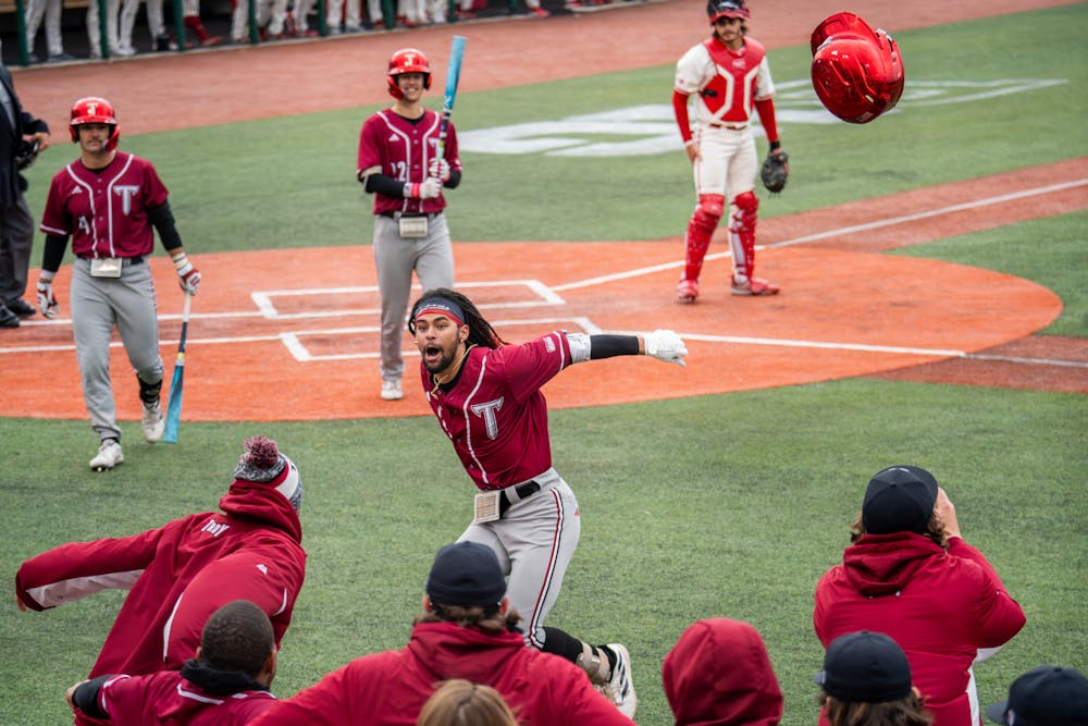 Troy shortstop Tremayne Cobb Jr. tosses his helmet and leaps toward his teammates after hitting a home run during Indiana's 8-1 loss to Troy on March 9, 2024. (HN photo/Danielle Stockwell)