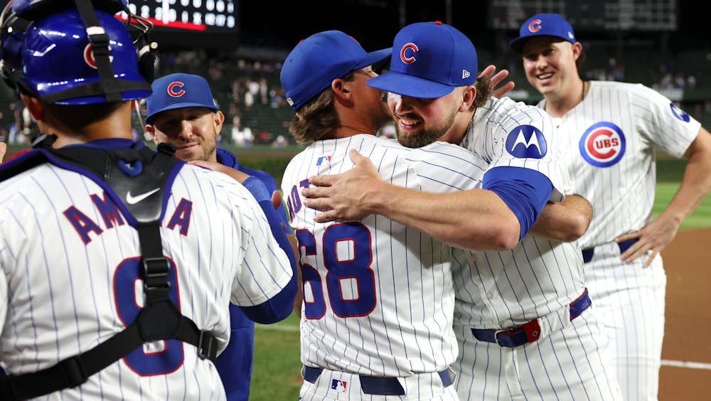 Chicago Cubs relief pitcher Porter Hodge and pitching coach Tommy Hottovy (68) embrace after Hodge, relief pitcher Nate Pearson (right), and starting pitcher Shota Imanaga, combined for a no-hitter against the Pittsburgh Pirates at Wrigley Field in Chicago on Sept. 4, 2024.  (Chris Sweda/Chicago Tribune)