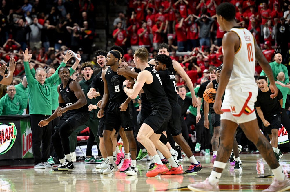 Michigan State's Tre Holloman (5) celebrates with teammates after hitting the game-winning shot at the buzzer against Maryland at Xfinity Center on Wednesday, Feb. 26, 2025, in College Park, Maryland. Michigan State won, 58-55. (Greg Fiume/Getty Images/TNS)