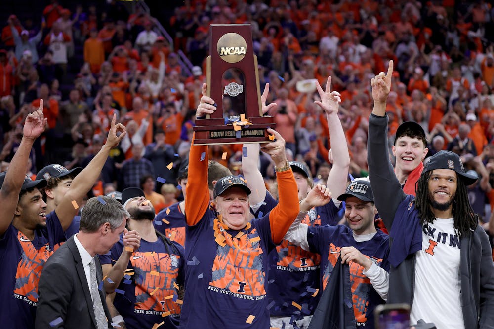 Illinois head coach Brad Underwood hoists the trophy with his team after defeating Iowa, 71-59, in the Elite Eight round of the NCAA Tournament at Toyota Center on Saturday, March 28, 2026, in Houston. (Alex Slitz/Getty Images/TNS)