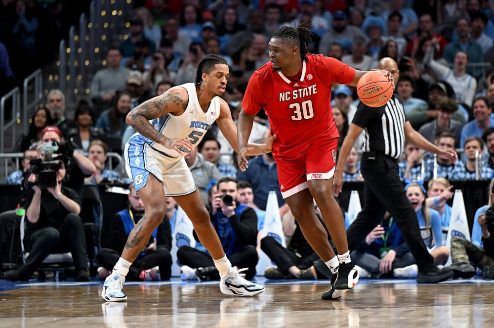 North Carolina State's DJ Burns Jr. (30) handles the ball in the first half against North Carolina's Armando Bacot (5) in the ACC Tournament final at Capital One Arena on Saturday, March 16, 2024, in Washington, D.C. (Greg Fiume/Getty Images/TNS)