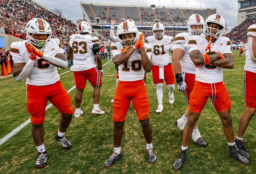 Miami Hurricanes running back Charmar Brown (6) wide receiver Malachi Toney (10) and wide receiver Keelan Marion (0) celebrate in the endzone after Toney scores to seal the game against the Virginia Tech Hokies late in the second half at Lane Stadium in Blacksburg, Virginia, on Saturday, November 22, 2025. (PHOTO BY AL DIAZ/Tribune Content Agency)