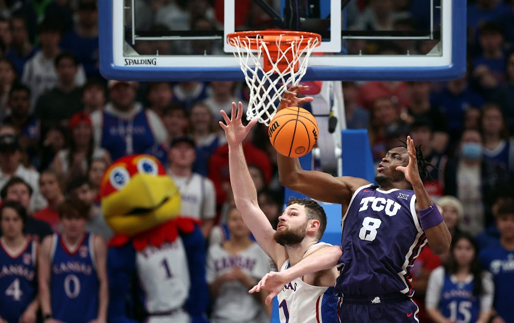 Kansas' Hunter Dickinson (1) and Texas Christian's Ernest Udeh Jr. (8) compete for a rebound during the second half at Allen Fieldhouse on Saturday, Jan. 6, 2024, in Lawrence, Kansas. (Jamie Squire/Getty Images/TNS)