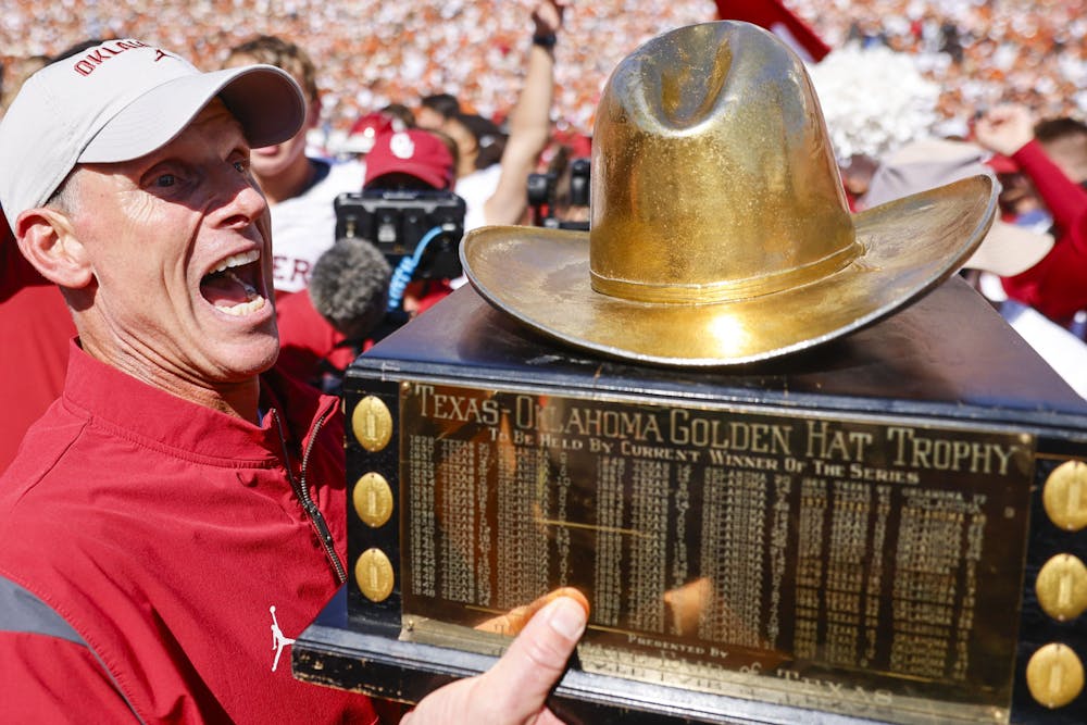Oklahoma coach Brent Venables cheers holding the trophy after winning the Red River Rivalry at the Cotton Bowl, on Saturday, Oct. 7, 2023, in Dallas. (Shafkat Anowar/Tribune Content Agency)