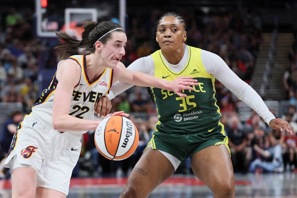 The Indiana Fever's Caitlin Clark (22) drives against the Seattle Storm's Victoria Vivians (35) during the first half at Gainbridge Fieldhouse on Thursday, May 30, 2024, in Indianapolis. (Andy Lyons/Getty Images/TNS)