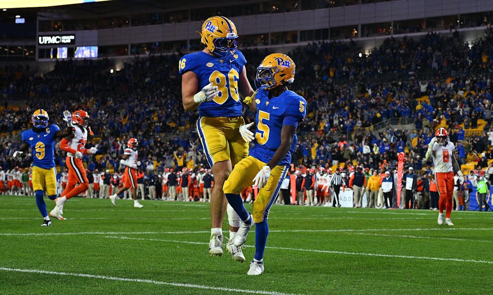 Pittsburgh wide receiver Raphael Williams Jr. (5) celebrates with teammate Gavin Bartholomew (86) after a 29-yard touchdown reception in the second half against Syracuse at Acrisure Stadium on Oct. 24, 2024, in Pittsburgh. (Justin Berl/Getty Images/TNS)