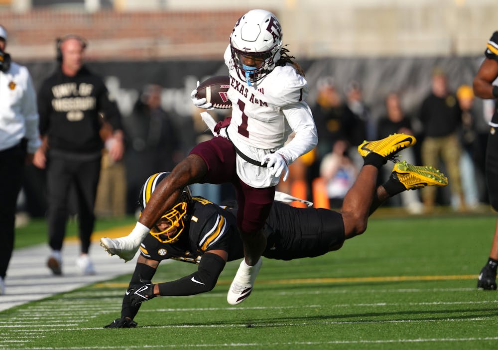 Texas A&M's Mario Craver evades the diving tackle bid from Missouri's Marvin Burks in the first half at Faurot Field at Memorial Stadium on Saturday, Nov. 8, 2025, in Columbia, Missouri. (Ed Zurga/Getty Images/TNS)