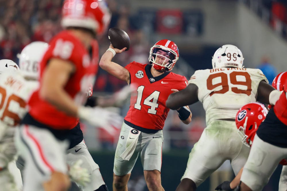Georgia quarterback Gunner Stockton (14) throws a 30-yard touchdown pass to Georgia wide receiver London Humphreys, left, during the fourth quarter against Texas in their NCAA football game at Sanford Stadium, Saturday, Nov. 15, 2025, in Athens, Ga. Georgia won 35-10. (Jason Getz/AJC/Tribune Content Agency)