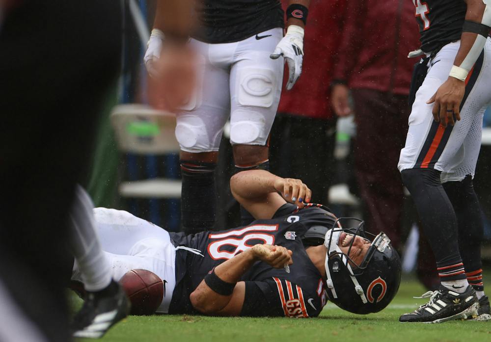 Chicago Bears quarterback Caleb Williams grimaces in pain after going down during a run in the fourth quarter against the Minnesota Vikings on Sunday, Sept. 20, 2026, at Soldier Field in Chicago. (Stacey Wescott/Chicago Tribune/TNS)