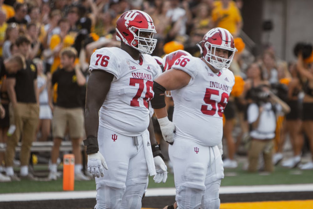 Indiana offensive linemen Matthew Bedford (left) and Mike Katic warm up before Indiana's 2021 season opener against Iowa. (HN photo)