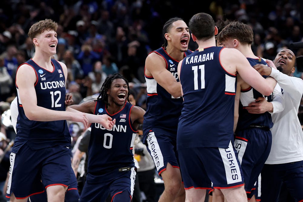 Braylon Mullins (24) celebrates with Malachi Smith (0), Alex Karaban (11), Jayden Ross (23) and Eric Reibe (12) of the UConn Huskies after defeating the Duke Blue Devils 73-72 in the Elite Eight of the 2026 NCAA Men's Basketball Tournament at Capital One Arena on Sunday, March 29, 2026, in Washington, D.C. (Emilee Chinn/Getty Images/TNS)