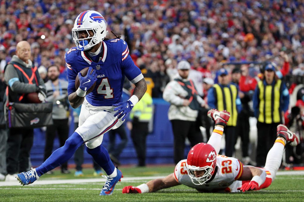 James Cook (4) of the Buffalo Bills scores a rushing touchdown against Drue Tranquill (23) of the Kansas City Chiefs during the first quarter at Highmark Stadium on Sunday, Nov. 17, 2024, in Orchard Park, New York. (Bryan M. Bennett/Getty Images/TNS)