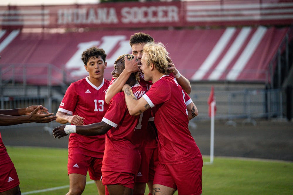 <p>Sam Sarver (right) celebrates with Collins Oduro (center) and other teammates after scoring during Indiana&#x27;s 1-0 win over Butler on Sept. 19, 2023. (HN photo/Danielle Stockwell)</p>
