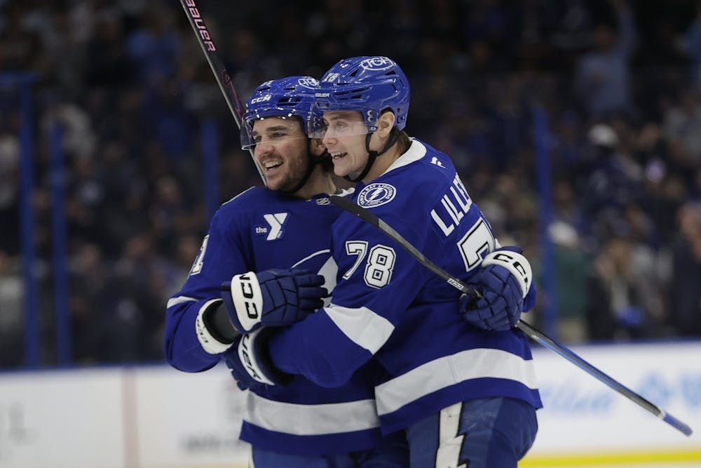 Lightning defenseman Emil Lilleberg (78) celebrates with defenseman Charle-Edouard D'Astous (51) after D'Astous' first-period goal against the Flames on Wednesday night. (Luis Santana/Tribune Content Agency)