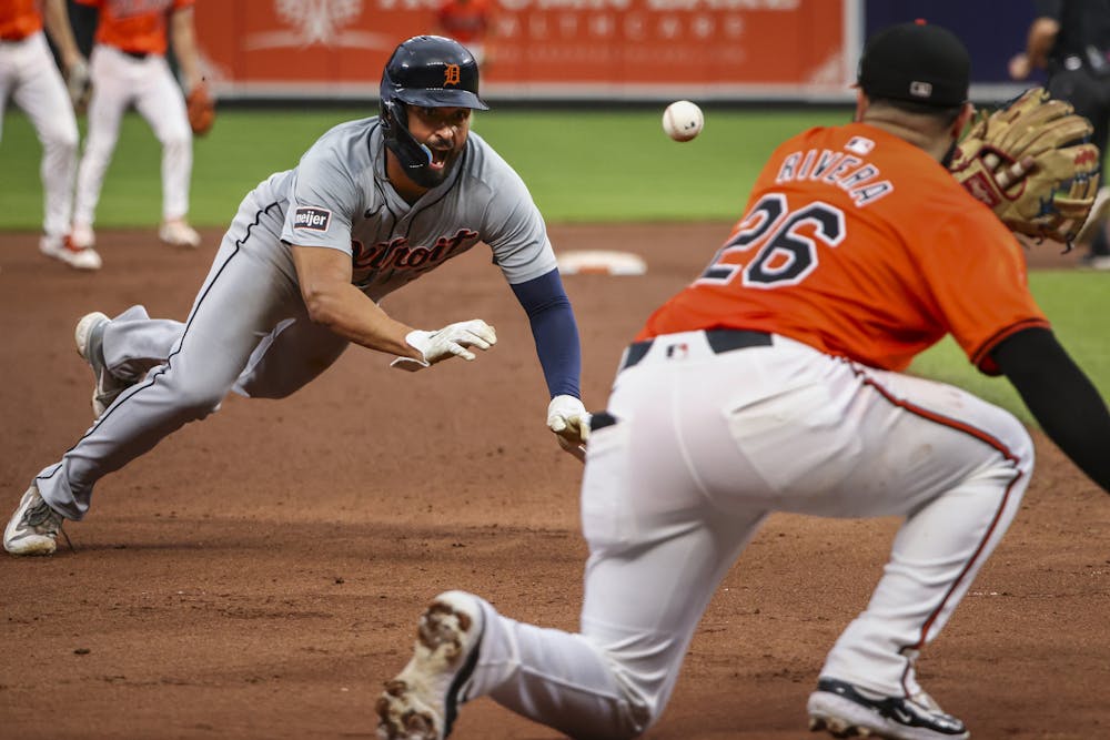 The Detroit Tigers' Riley Greene, left, dives safely for third base in the eighth inning as the Baltimore Orioles' Emmanuel Rivera (26) fields the throw at Oriole Park at Camden Yards on Saturday, Sept. 21, 2024, in Baltimore. (Samuel Corum/Getty Images/TNS)