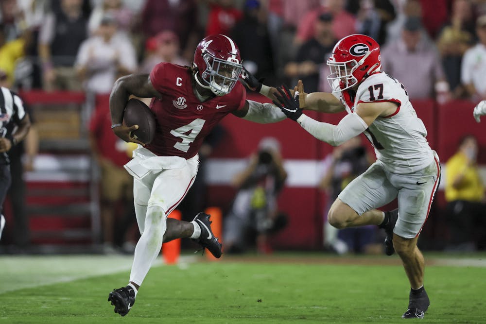 Alabama quarterback Jalen Milroe (4) runs for a first down against Georgia defensive back Dan Jackson (17) during the second quarter at Bryant-Denny Stadium, Saturday, Sept. 28, 2024, in Tuscaloosa, Al. (Jason Getz / AJC)