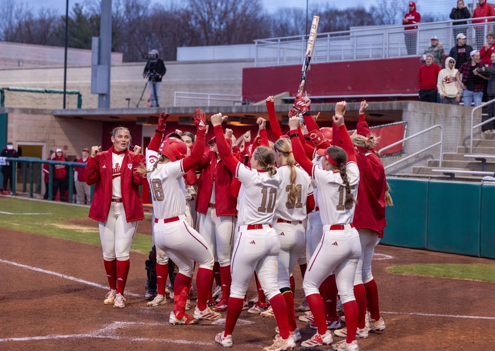 Indiana players mob Avery Parker after her walk-off home run to end Indiana's win over Rutgers on March 13, 2026. (HN photo/Lindsey Soet)