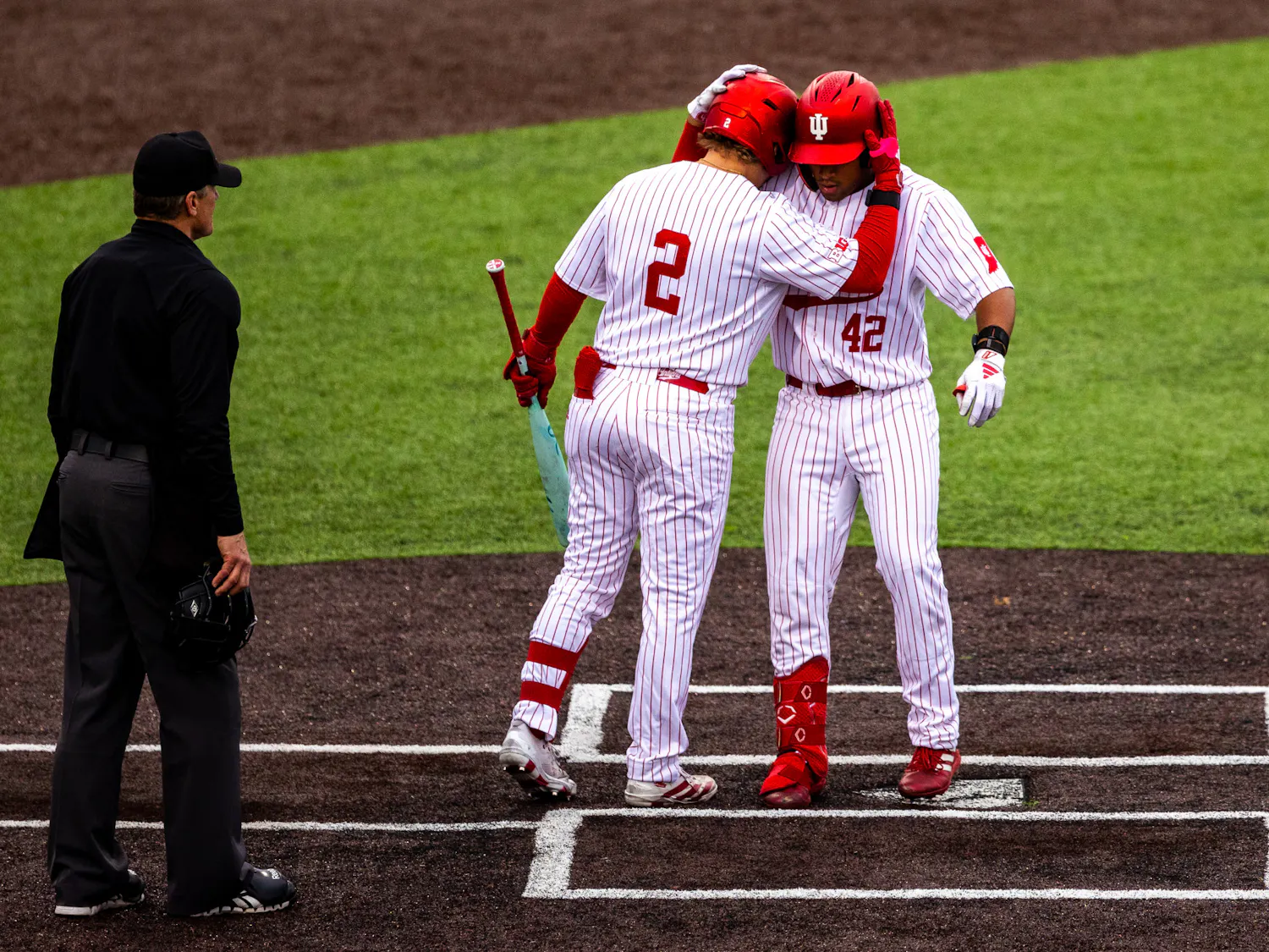 Hogan Denny (2) greets Brayden Ricketts at home plate after Ricketts' home run during Indiana's loss to Abilene Christian on April 18, 2026. (HN photo/Lauren McKinney)