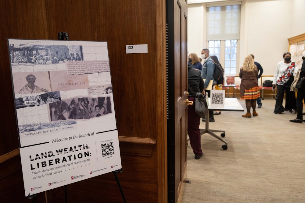 <p>Patrons explore the pop-up exhibit of material from the Herman B Wells Library, Education Library and Lilly Library at the Land, Wealth, Liberation launch event. Librarians across the IU campus worked to compile a timeline called &quot;Land, Wealth, Liberation: The Making and Unmaking of Black Wealth in the United States,&quot; which includes sources and artifacts from 1820 to 2020.</p><p></p>
