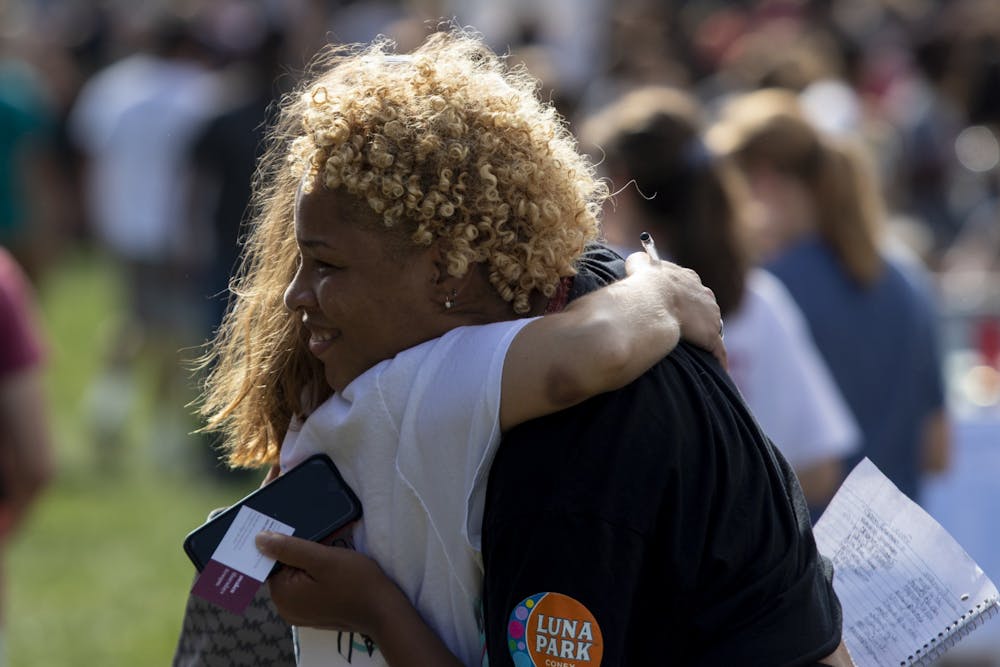 <p>Then-sophomore Xakilah Daniel hugs then-senior Ellie Johnson during the Student Involvement Fair on Aug. 29, 2019, in Dunn Meadow. The fair and many other extracurricular events have been changed due to the coronavirus pandemic.</p>