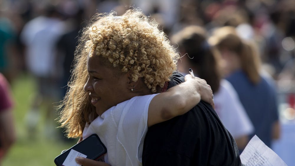 Then-sophomore Xakilah Daniel hugs then-senior Ellie Johnson during the Student Involvement Fair on Aug. 29, 2019, in Dunn Meadow. The fair and many other extracurricular events have been changed due to the coronavirus pandemic.