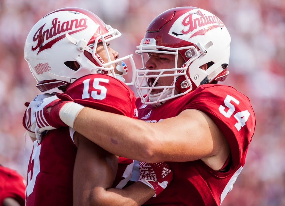 Freshman offensive lineman Coy Cronk, 54, congratulates sophomore wide receiver Nick Westbrook after scoring against Wake Forest during the first half. 