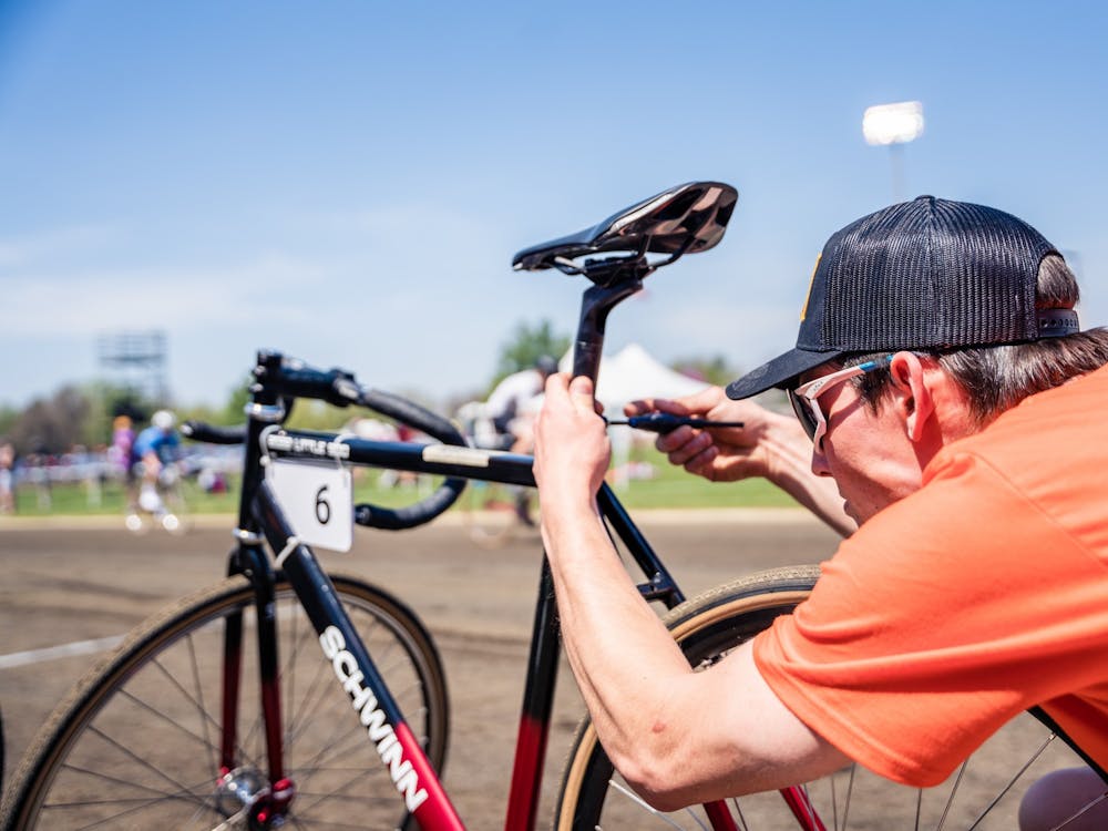 A bike mechanic for Mother Bears preps a bike before the Men&#x27;s Little 500 on April 23, 2022, at Bill Armstrong Stadium. The teams had mechanical tools in their pits as well. 