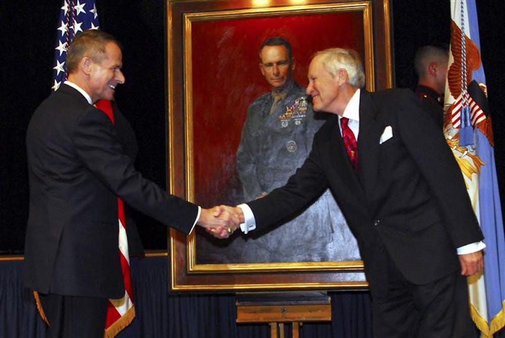 Former chairman of the Joint Chiefs of Staff, retired Marine Corps Gen. Peter Pace greets portrait artist Peter E. Egeli following the unveiling of Pace's portrait. The portrait was unveiled Friday during a ceremony at the Pentagon. The painting will be displayed in a corridor of the Pentagon along with portraits of other former chairmen.